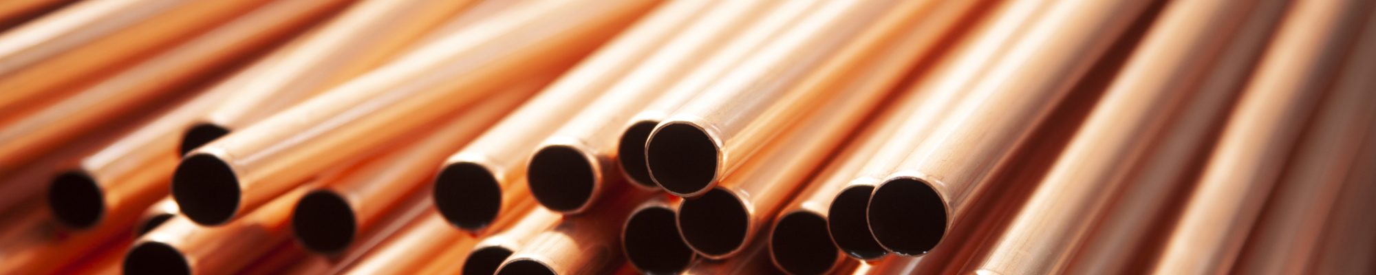 Copper pipes in factory, industrial background